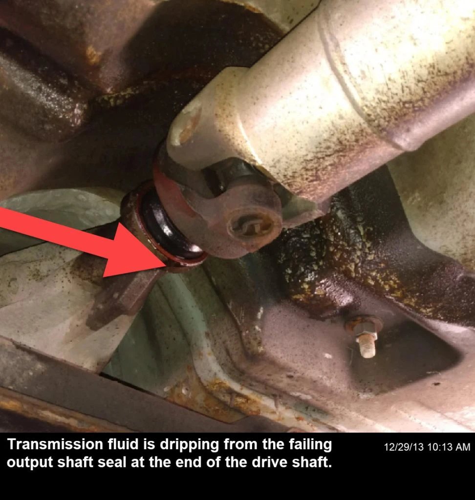 Transmission output shaft seal leak, causing symptoms like grinding noises, transmission issues, vibrations, and burning smells