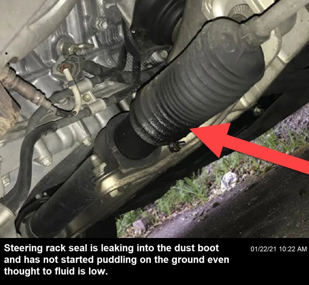 A faulty steering rack seal allows leak to seep into the dust boot, lowering oil level