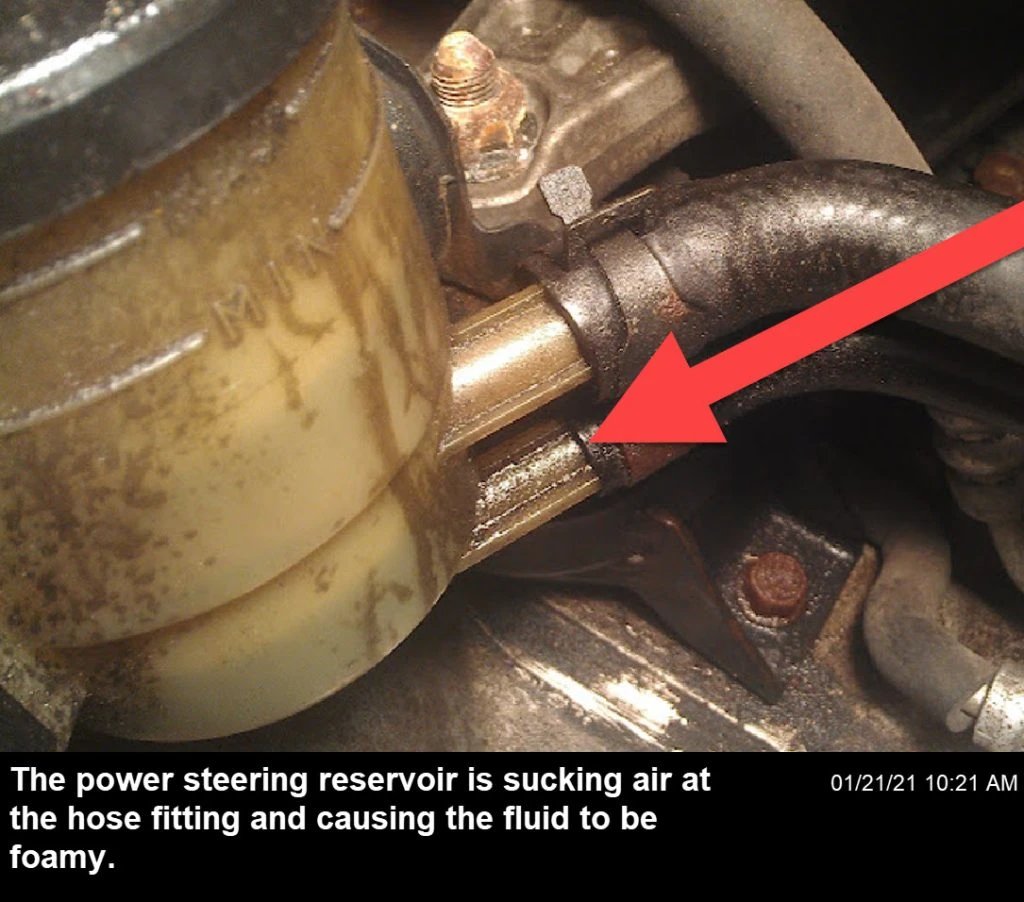 A leak in the power steering reservoir is allowing air to get in, making the fluid inside foamy