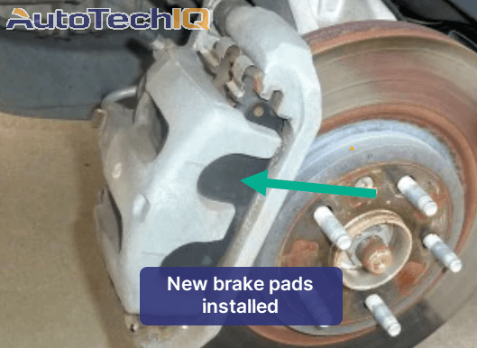 Picture of brand new brake pads installed on a rotor